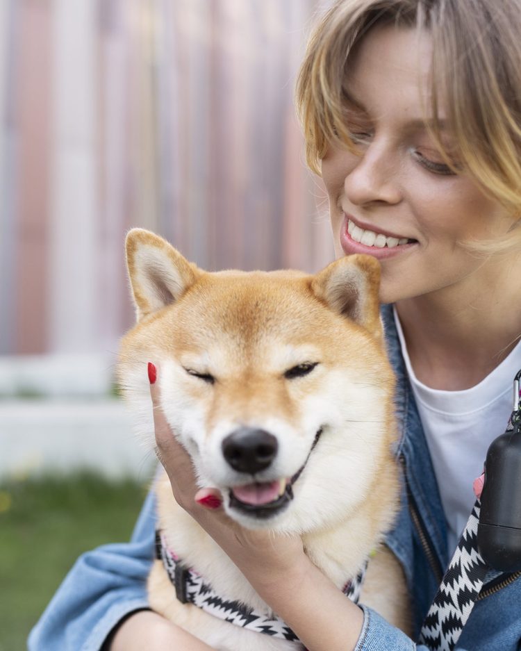 Woman smiling with a Shiba, an image used on the NorCal Shiba website
