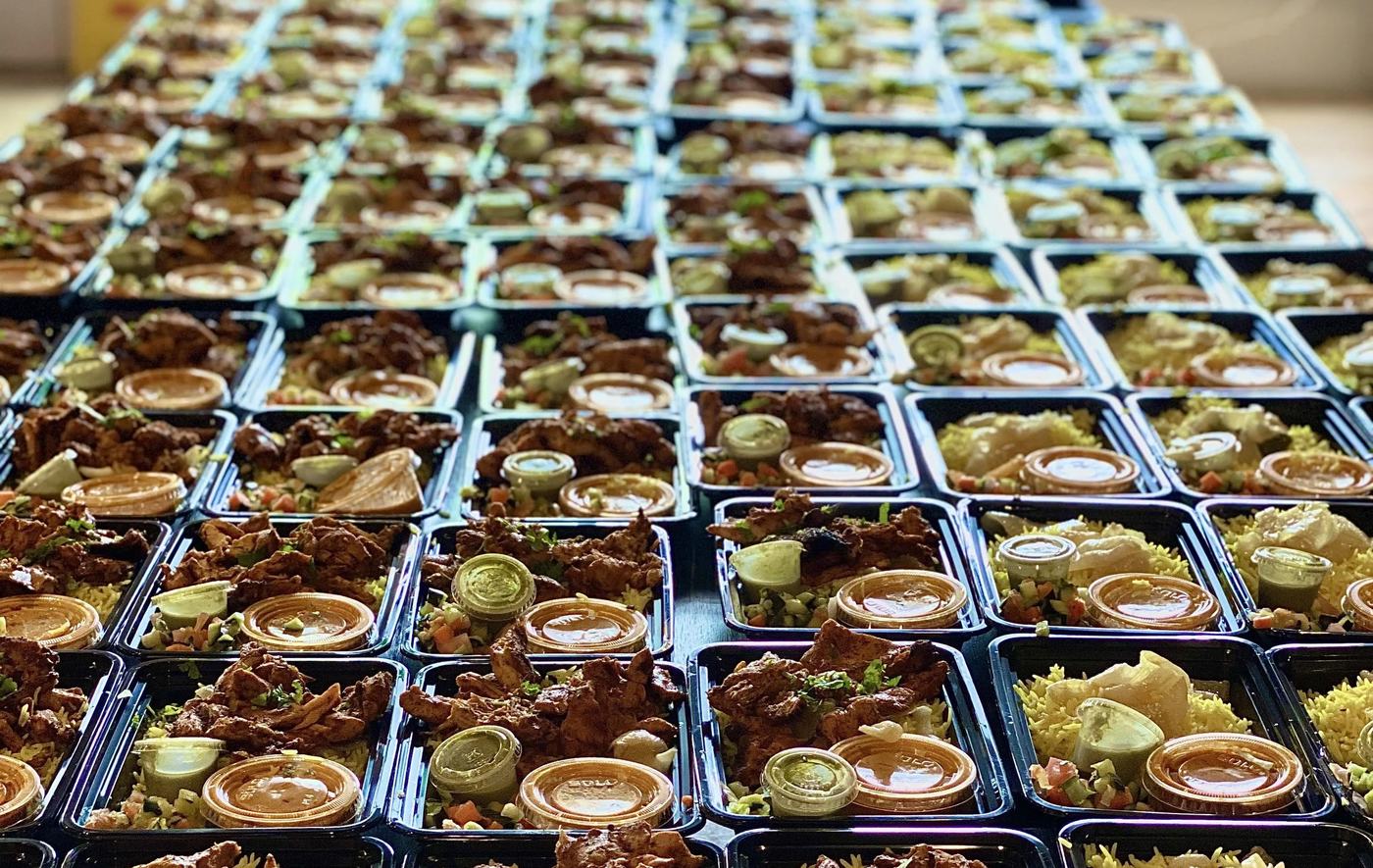Rows of prepared catering orders boxed and staged for service at Zareen&rsquo;s.